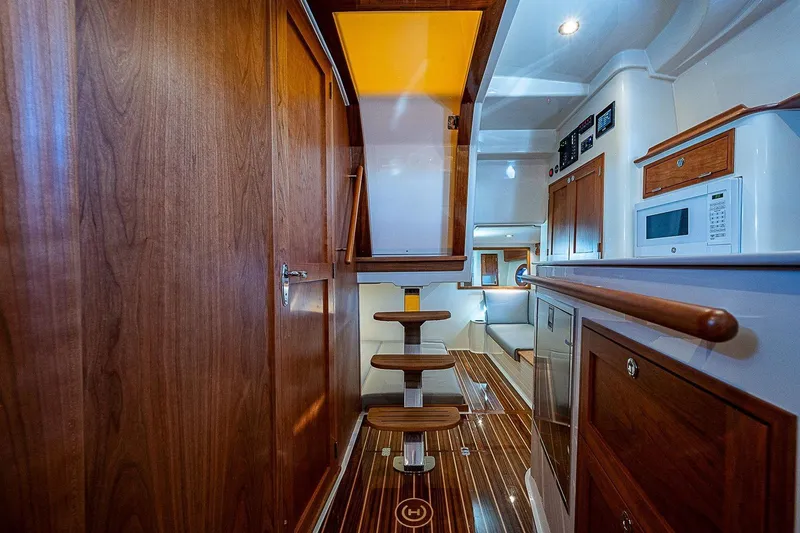  Yacht Photos Pics Luxurious interior of 2023 Hinckley 40x yacht with wooden finishes and modern amenities.