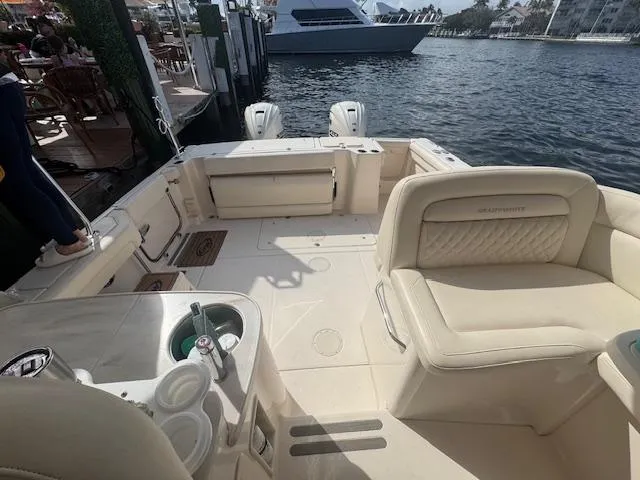 Texas Crewed Yacht Photos Pics 2024 Grady-White Freedom 335 boat interior with seating, docked by the water.