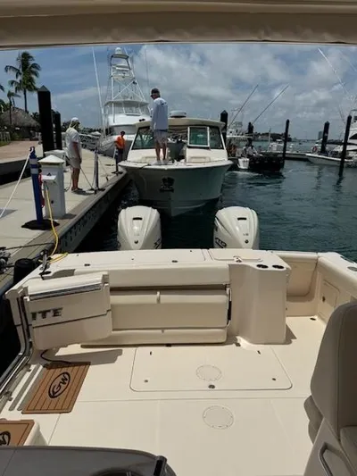 Texas Crewed Yacht Photos Pics 2024 Grady-White Freedom 335 boat docked at marina with people onboard.