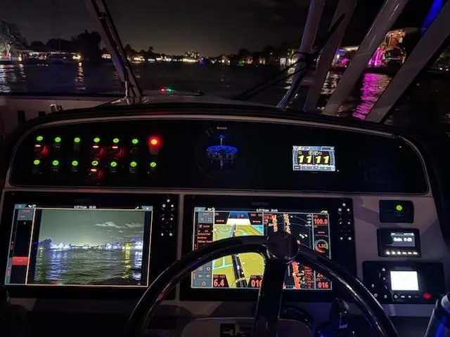 Texas Crewed Yacht Photos Pics 2024 Grady-White Freedom 335 boat dashboard at night with illuminated controls and screens.