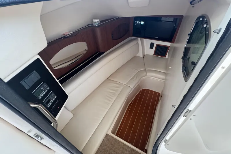 Texas Crewed Yacht Photos Pics 2024 Grady-White Freedom 335 cabin interior with white seating and wood accents.