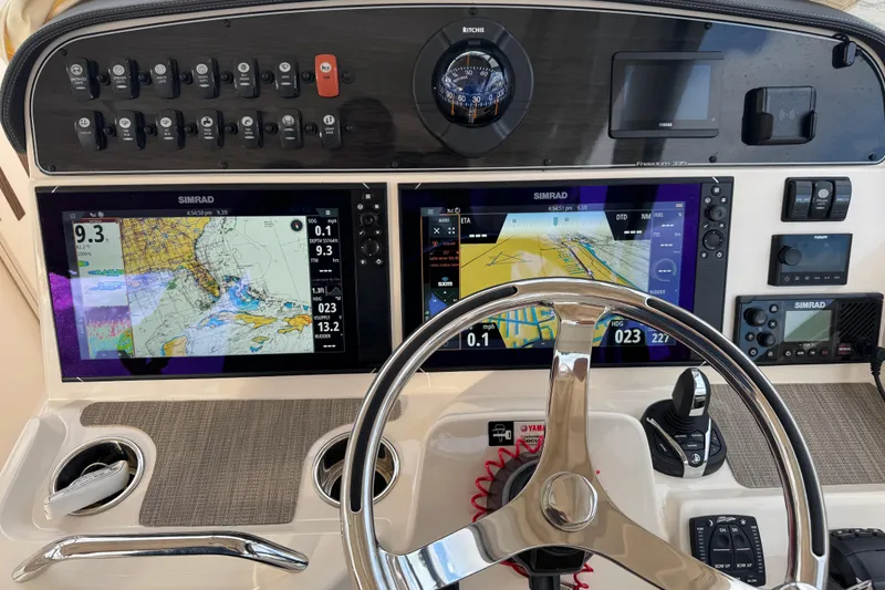 Texas Crewed Yacht Photos Pics 2024 Grady-White Freedom 335 dashboard with dual Simrad displays and steering wheel.