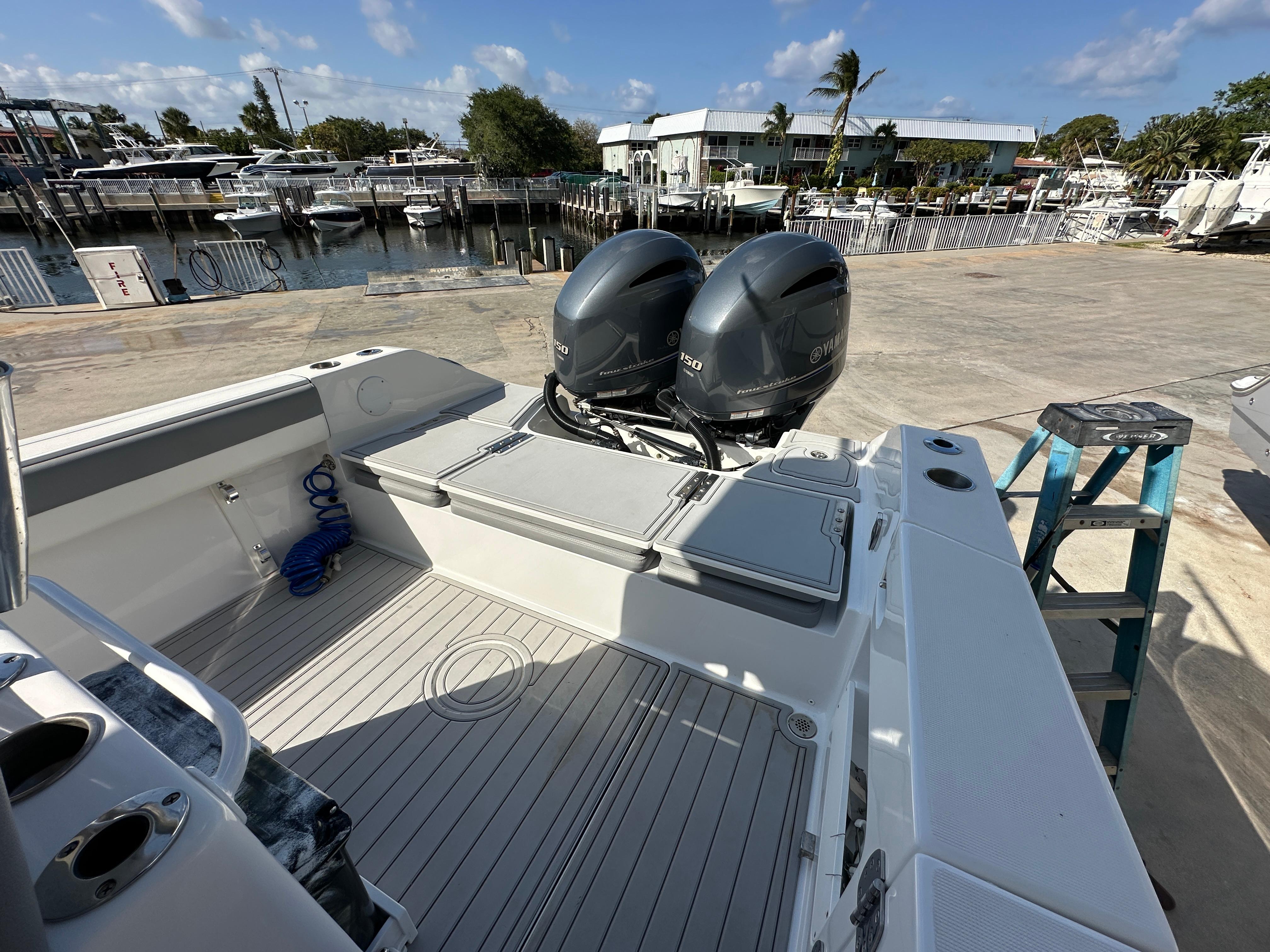 2021 Release 240 RX boat with dual outboard motors docked at a marina.