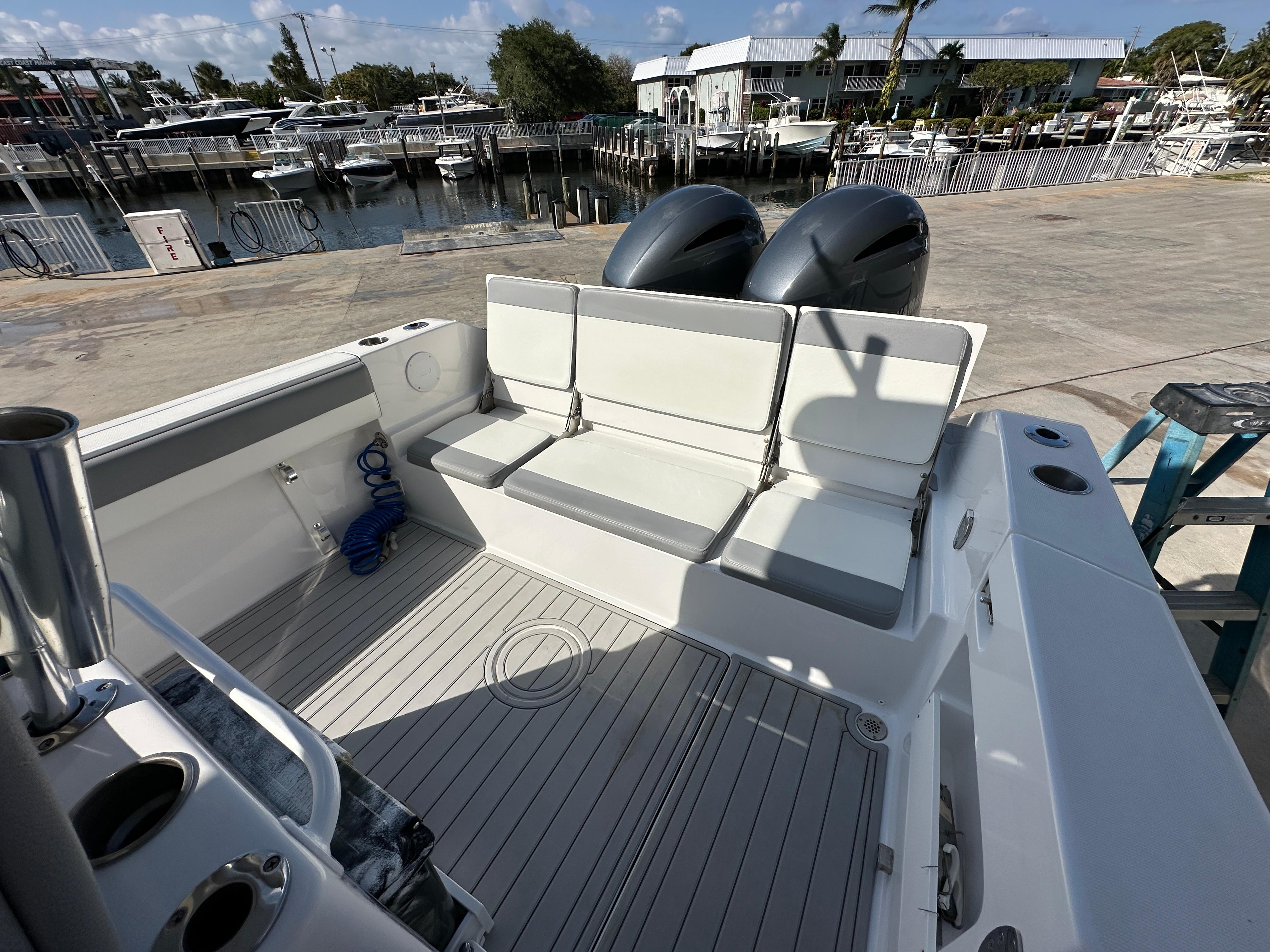 2021 Release 240 RX boat with seating, docked at marina under clear sky.