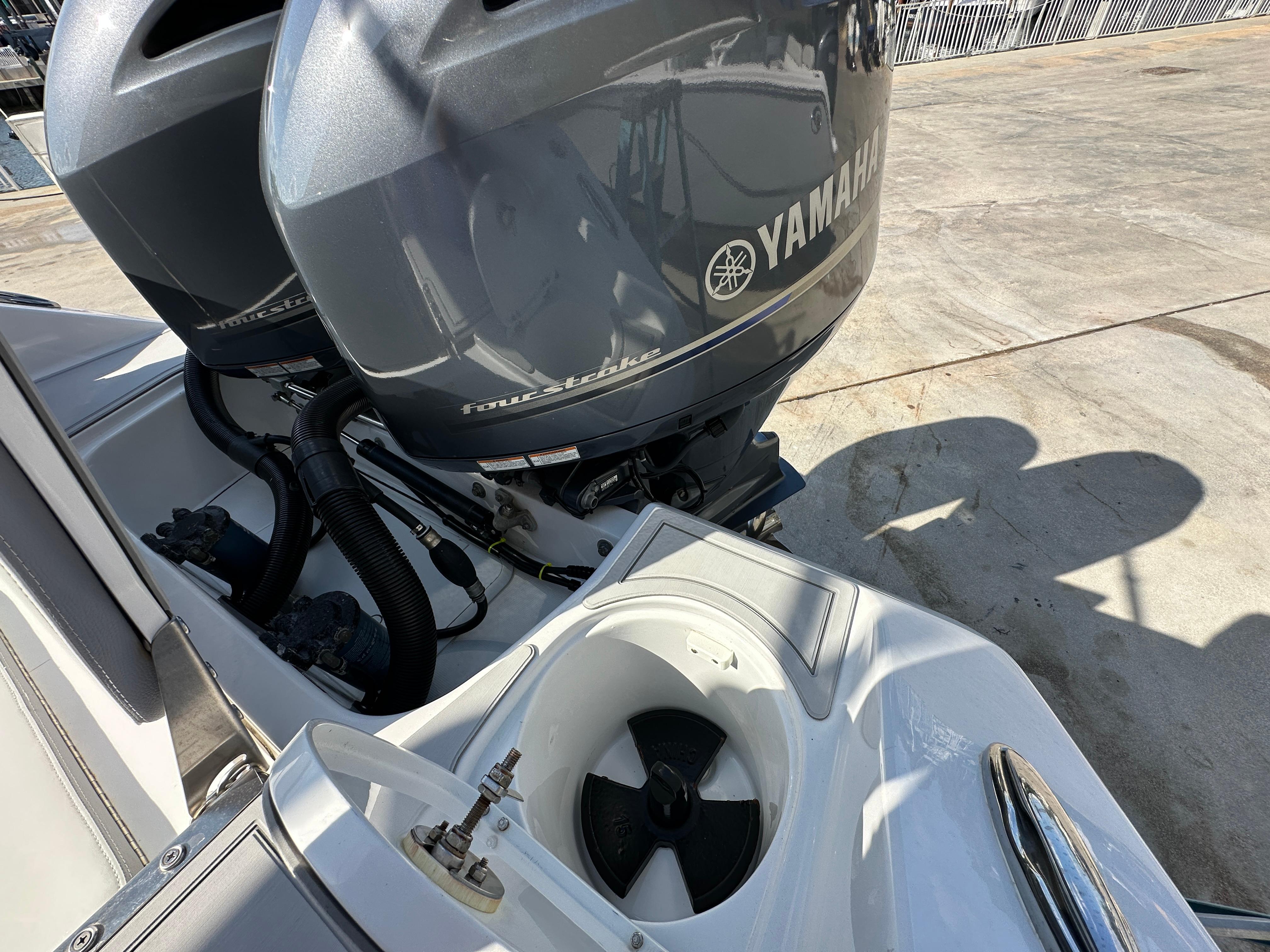 Twin Yamaha outboard motors on a 2021 Release 240 RX boat, dockside view.