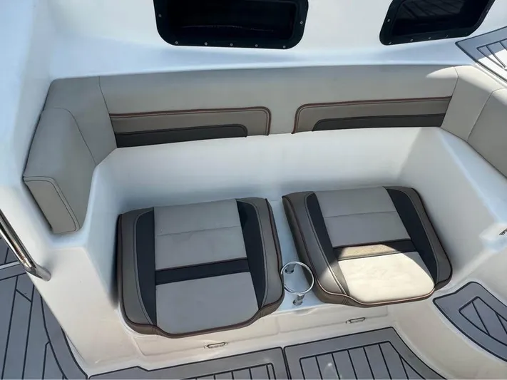  Yacht Photos Pics 2023 Solara S-310 CW boat seating area with cushioned seats and cup holder.