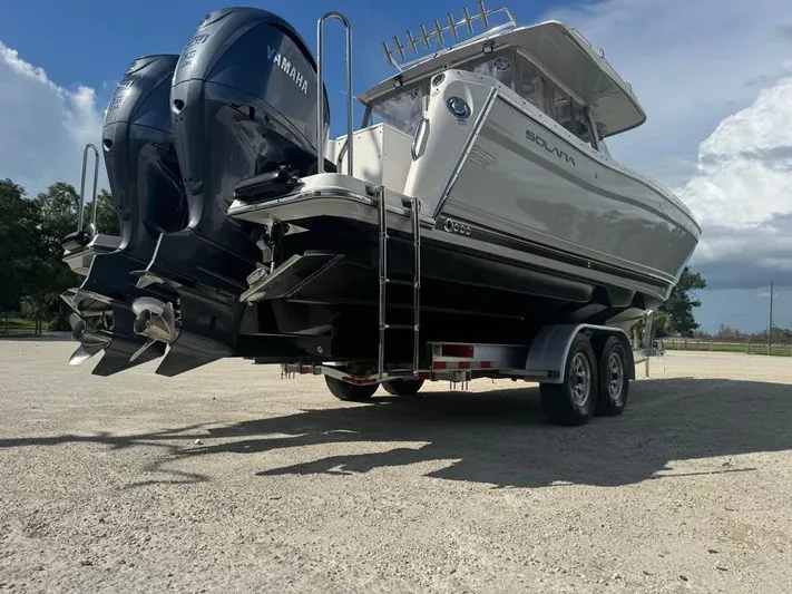  Yacht Photos Pics 2023 Solara S-310 CW boat on trailer with Yamaha engines, parked outdoors.