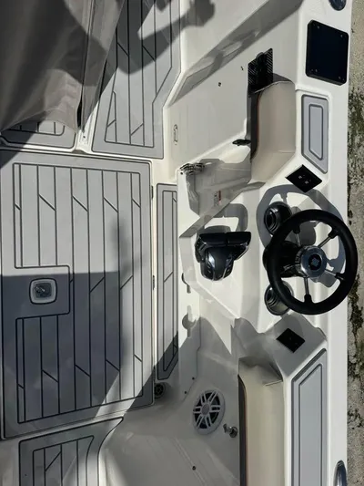  Yacht Photos Pics 2023 Solara S-310 CW boat cockpit with steering wheel and controls.