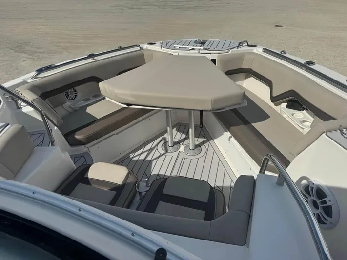 Yacht Photos Pics 2023 Solara S-310 CW boat interior with cushioned seating and table.