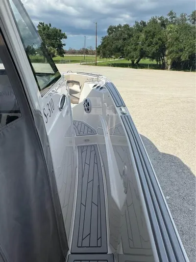  Yacht Photos Pics 2023 Solara S-310 CW boat with sleek deck design, parked outdoors.