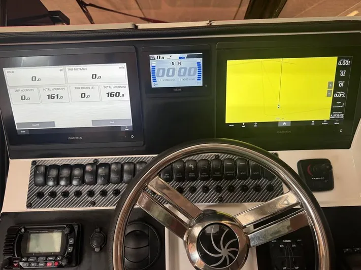  Yacht Photos Pics Dashboard of 2023 Solara S-310 CW boat with digital displays and steering wheel.