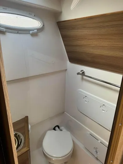  Yacht Photos Pics 2023 Solara S-310 CW boat bathroom with modern design and wood accents.