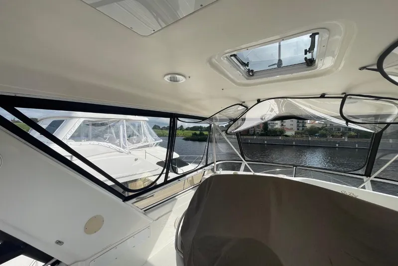Double Kickback IV Yacht Photos Pics Interior view of a 1998 Sea Ray 480 Sedan Bridge yacht with waterway backdrop.