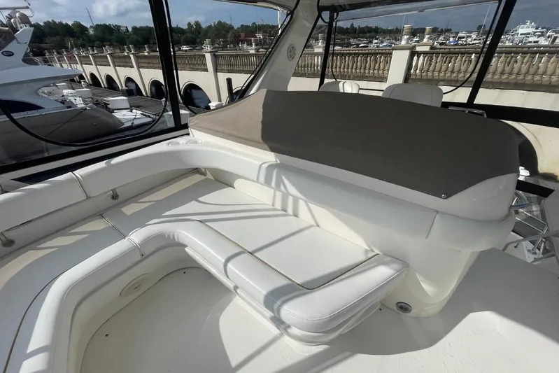 Double Kickback IV Yacht Photos Pics 1998 Sea Ray 480 Sedan Bridge interior with white seating and marina view.
