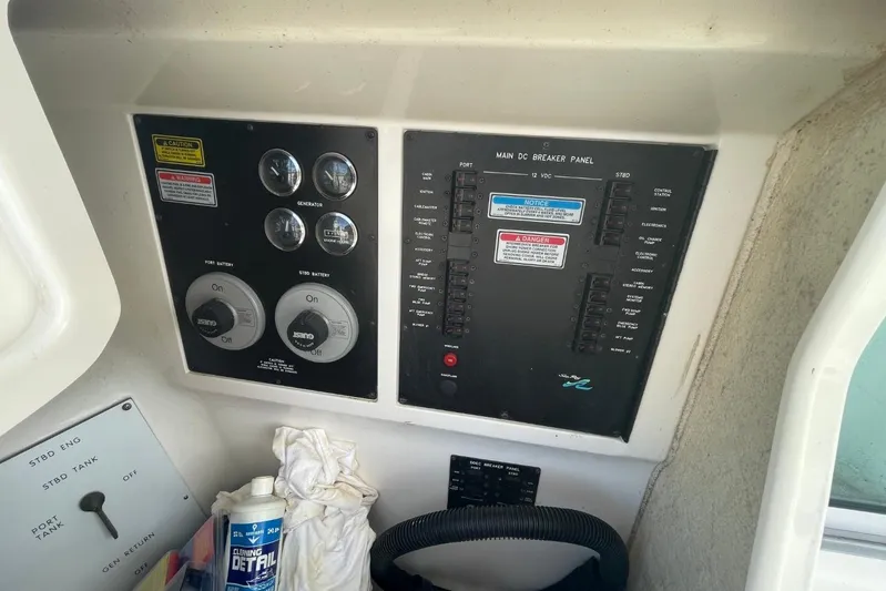 Double Kickback IV Yacht Photos Pics 1998 Sea Ray 480 Sedan Bridge control panel with gauges and cleaning supplies.