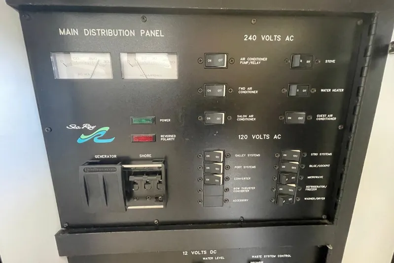 Double Kickback IV Yacht Photos Pics Main distribution panel of 1998 Sea Ray 480 Sedan Bridge yacht, showing AC and DC controls.