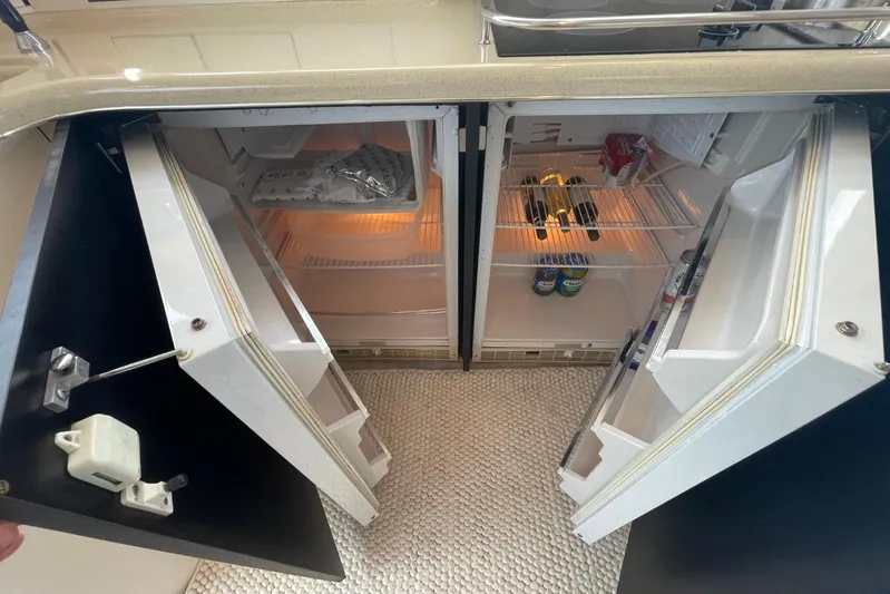 Double Kickback IV Yacht Photos Pics Interior view of 1998 Sea Ray 480 Sedan Bridge yacht's dual refrigerators.