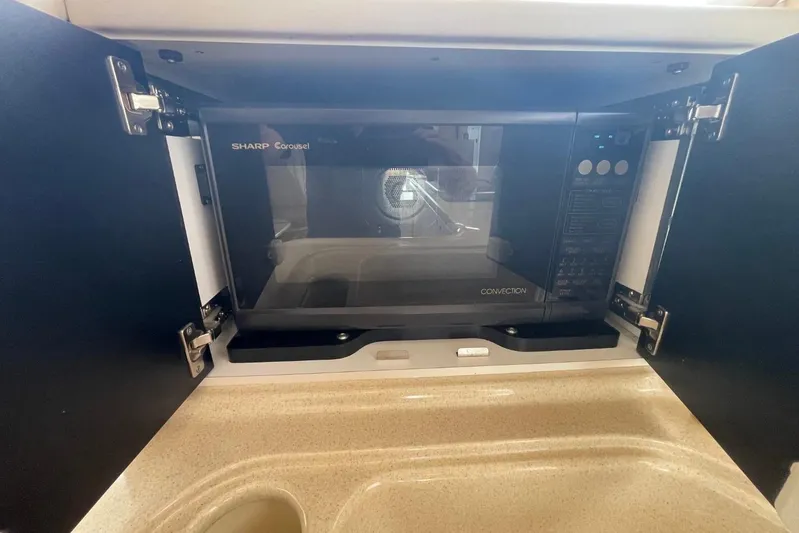 Double Kickback IV Yacht Photos Pics Sharp Carousel convection microwave in 1998 Sea Ray 480 Sedan Bridge kitchen.
