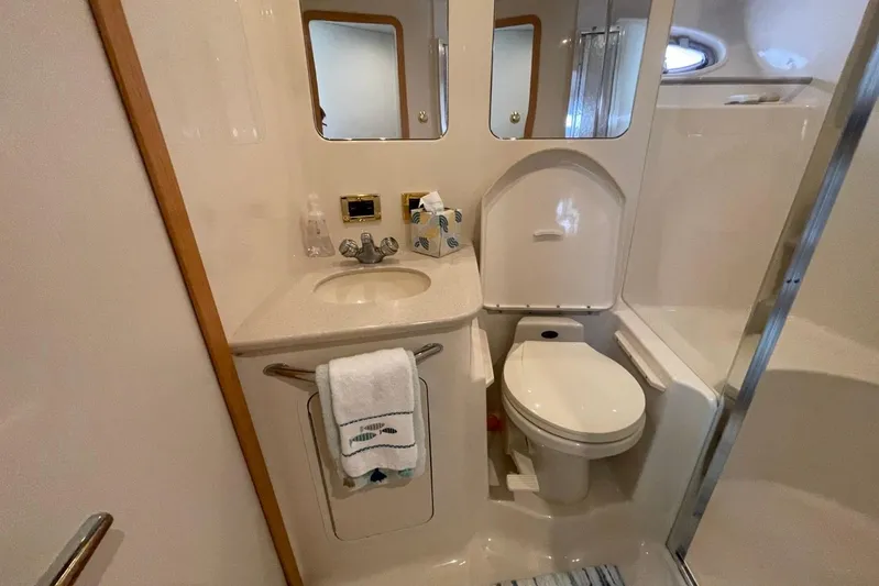 Double Kickback IV Yacht Photos Pics 1998 Sea Ray 480 Sedan Bridge bathroom with sink, toilet, and shower.