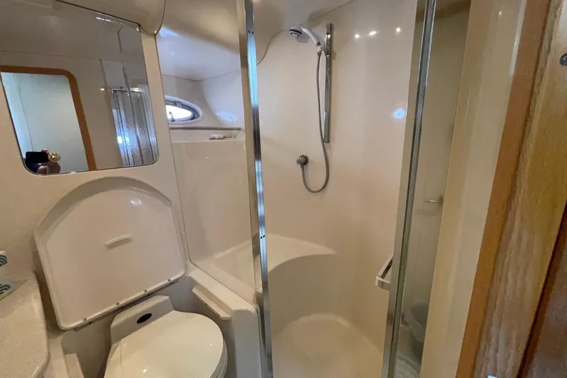 Double Kickback IV Yacht Photos Pics Bathroom interior of 1998 Sea Ray 480 Sedan Bridge yacht, featuring shower and toilet.