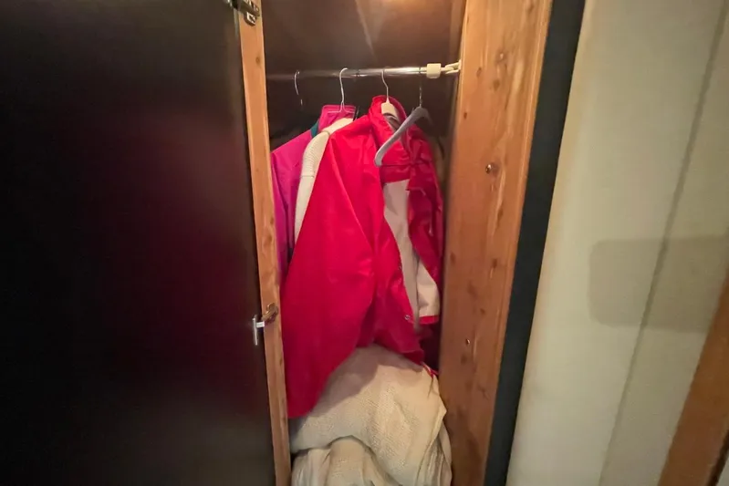 Double Kickback IV Yacht Photos Pics Closet with red jackets and blankets inside a 1998 Sea Ray 480 Sedan Bridge.