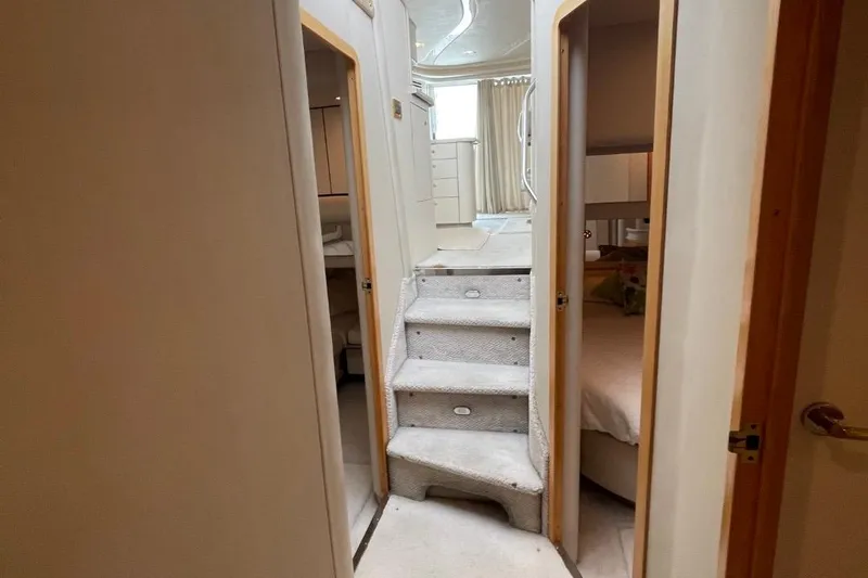 Double Kickback IV Yacht Photos Pics Interior of 1998 Sea Ray 480 Sedan Bridge yacht with carpeted stairs and cozy cabins.