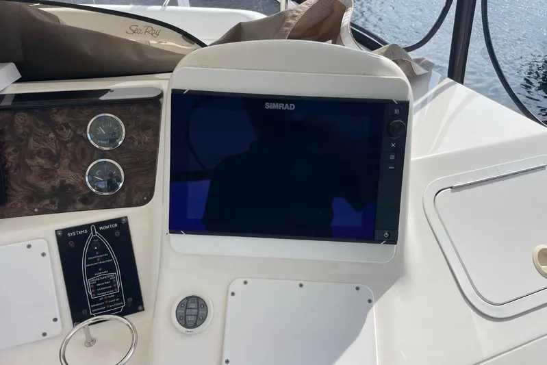 Double Kickback IV Yacht Photos Pics Control panel of a 1998 Sea Ray 480 Sedan Bridge with Simrad display.