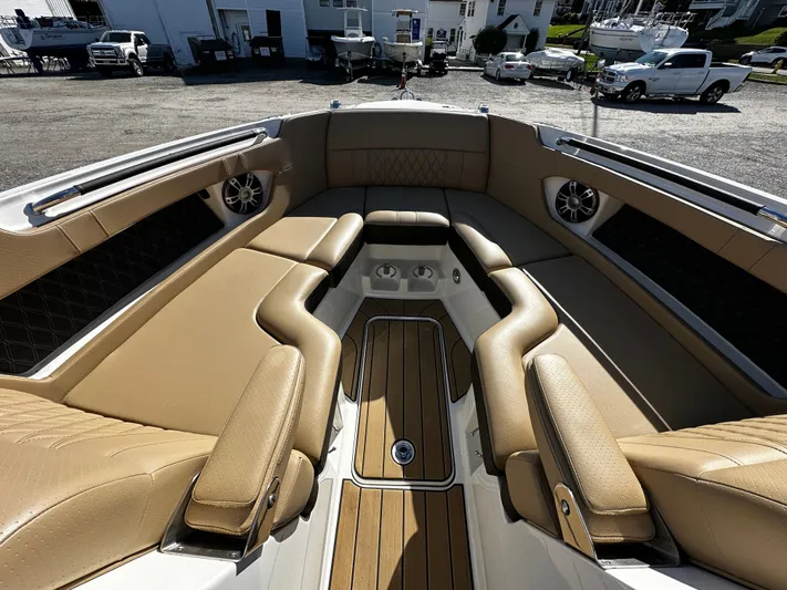  Yacht Photos Pics Luxurious seating area on 2023 Sea Ray 280 SLX boat, featuring tan upholstery and speakers.