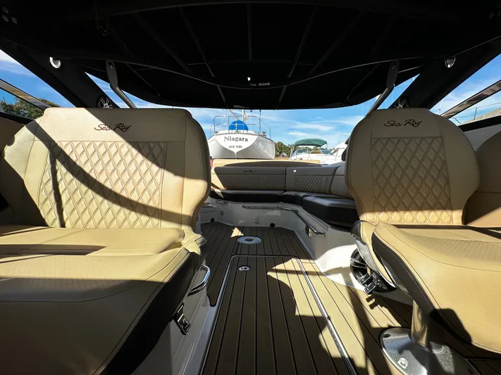  Yacht Photos Pics Interior of 2023 Sea Ray 280 SLX boat with luxurious seating and wood flooring.