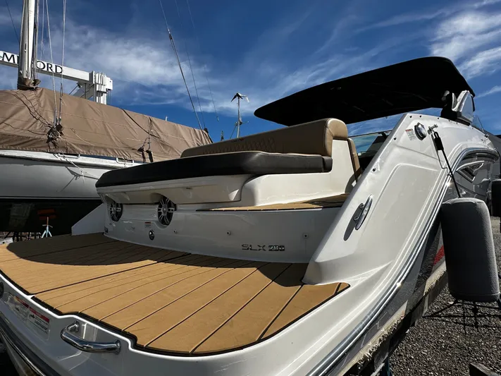  Yacht Photos Pics 2023 Sea Ray 280 SLX boat with sleek design and spacious deck under blue sky.