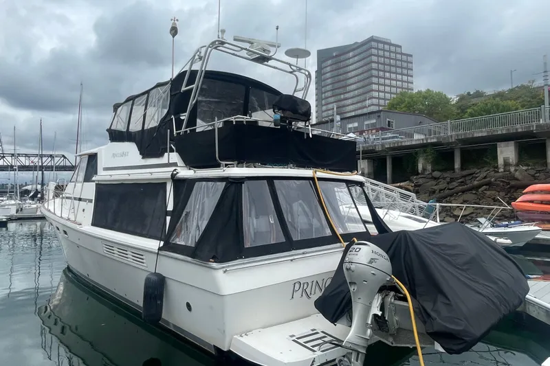  Yacht Photos Pics 1989 Bayliner Pilothouse 4588 yacht docked at marina under cloudy skies.