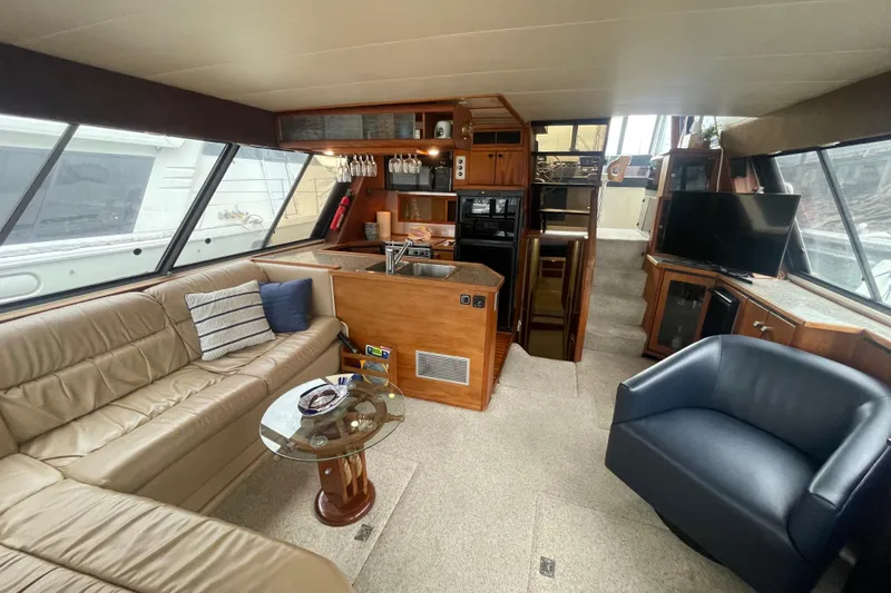  Yacht Photos Pics Luxurious interior of 1989 Bayliner Pilothouse 4588 yacht with modern amenities and seating.