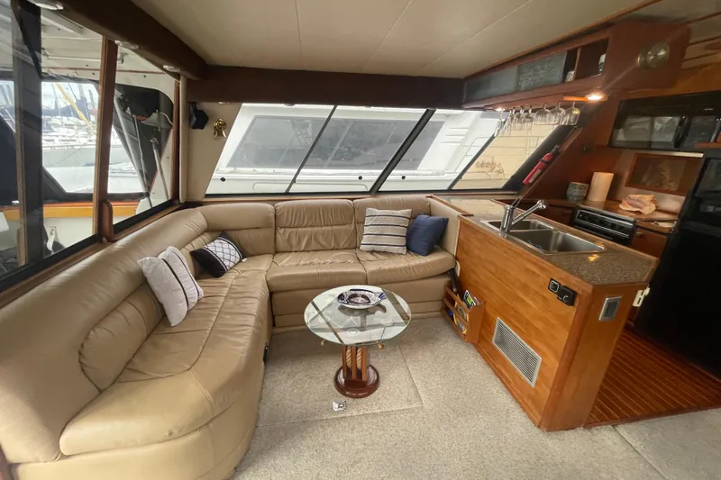  Yacht Photos Pics Interior of 1989 Bayliner Pilothouse 4588 with leather seating and kitchenette.