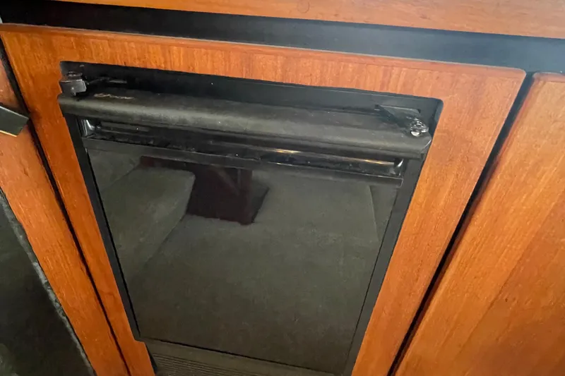  Yacht Photos Pics 1989 Bayliner Pilothouse 4588 interior with wooden cabinetry and built-in appliance.