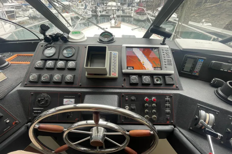  Yacht Photos Pics 1989 Bayliner Pilothouse 4588 helm with navigation instruments and steering wheel.