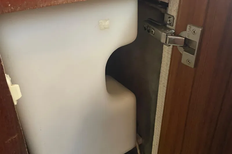  Yacht Photos Pics 1989 Bayliner Pilothouse 4588 interior cabinet with white plastic container.