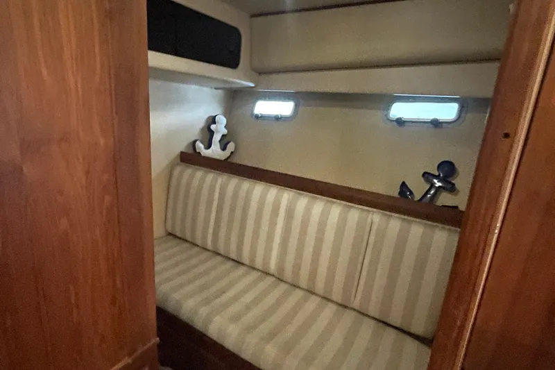  Yacht Photos Pics 1989 Bayliner Pilothouse 4588 interior with striped seating and nautical decor.