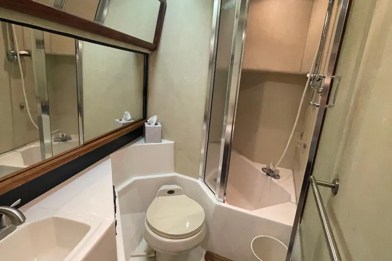  Yacht Photos Pics Bathroom interior of 1989 Bayliner Pilothouse 4588 with shower and toilet.