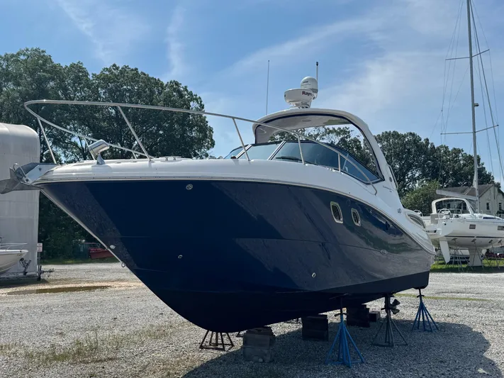 Max Dream Yacht Photos Pics 2014 Sea Ray 330 Sundancer boat on stands, blue hull, outdoor storage.