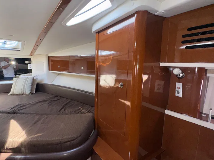 Max Dream Yacht Photos Pics Interior cabin of 2014 Sea Ray 330 Sundancer with wood finish and cozy bedding.