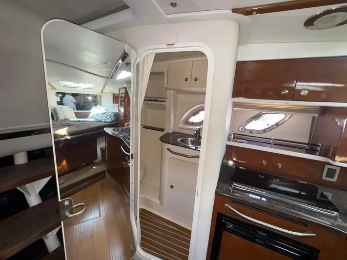 Max Dream Yacht Photos Pics Interior of 2014 Sea Ray 330 Sundancer yacht with modern kitchen and cozy cabin.