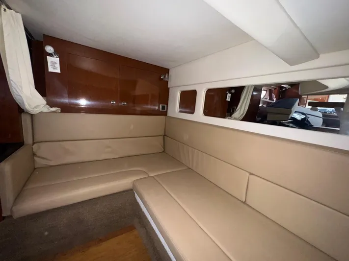 Max Dream Yacht Photos Pics Interior of 2014 Sea Ray 330 Sundancer with beige seating and wooden cabinetry.