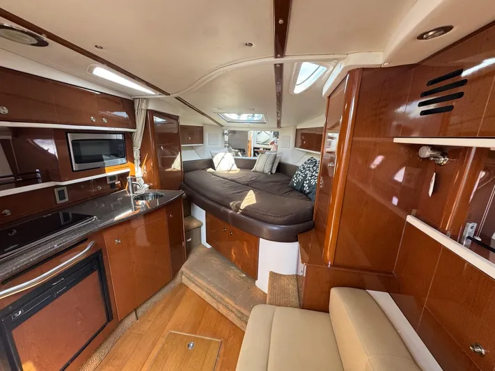 Max Dream Yacht Photos Pics Interior of 2014 Sea Ray 330 Sundancer yacht with modern kitchen and cozy sleeping area.