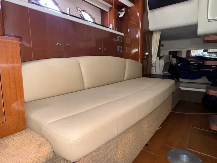 Max Dream Yacht Photos Pics Interior of 2014 Sea Ray 330 Sundancer with beige seating and wooden cabinetry.