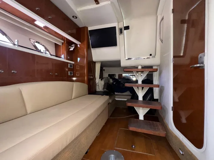 Max Dream Yacht Photos Pics Interior of 2014 Sea Ray 330 Sundancer with beige seating and wooden steps.