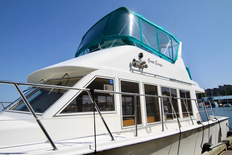  Yacht Photos Pics 1999 McKinna 47 Sedan yacht docked, featuring sleek design and spacious windows.