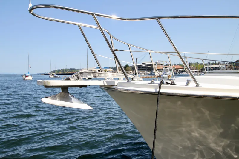  Yacht Photos Pics 1999 McKinna 47 Sedan yacht on calm water with clear blue sky.