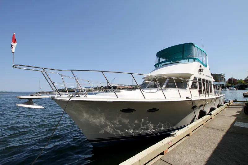  Yacht Photos Pics 1999 McKinna 47 Sedan yacht docked by the waterfront on a sunny day.