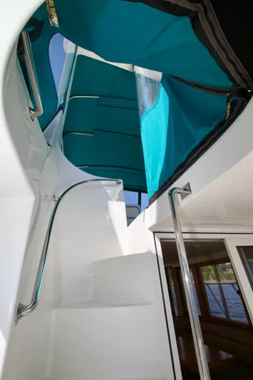  Yacht Photos Pics Staircase on 1999 McKinna 47 Sedan yacht with teal canopy.