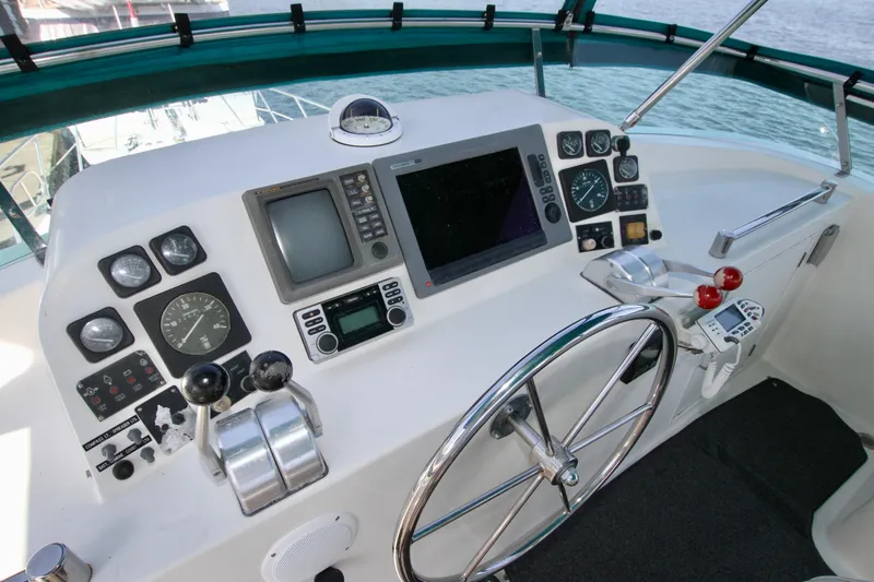  Yacht Photos Pics 1999 McKinna 47 Sedan yacht helm with navigation instruments and steering wheel.